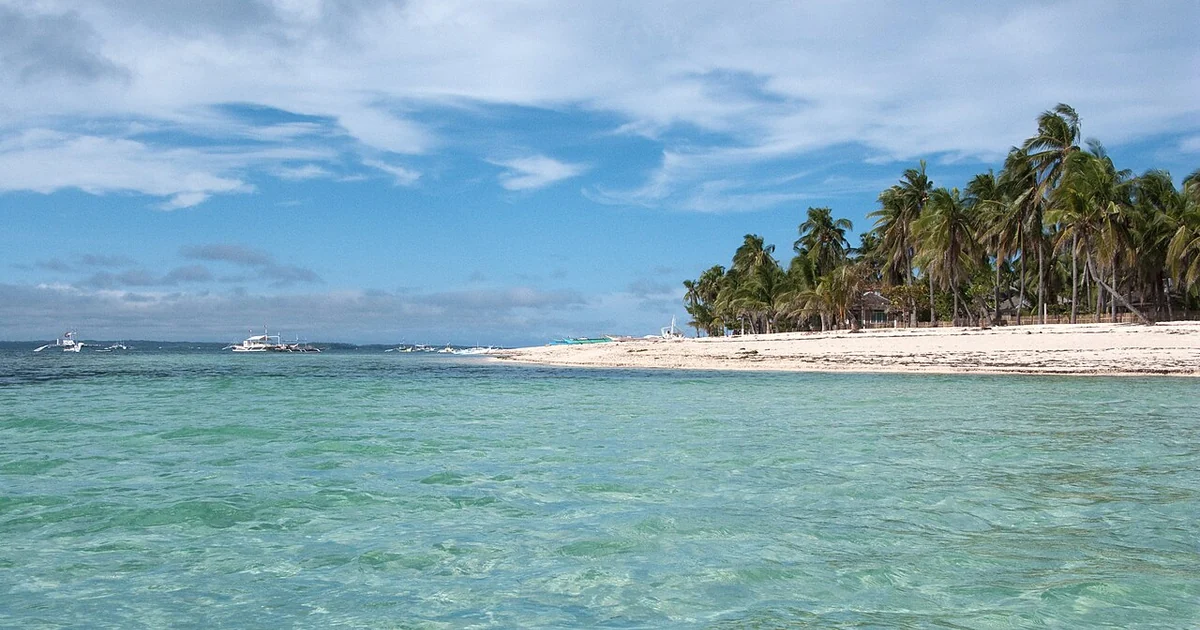 Tropical beach. Crystal clear blue water. Malapascua (island), Central Visayas, Philippines.